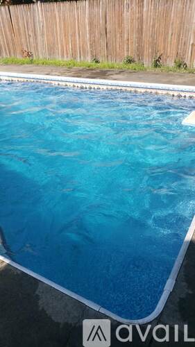 A pool with a blue tinted water.