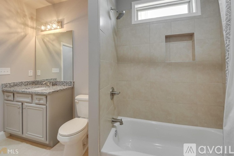 A bathroom with a toilet, sink, and bathtub.
