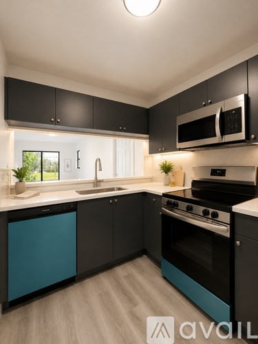 A modern kitchen with black cabinets and a blue dishwasher.