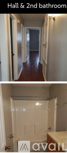 A long hallway with doors on both sides leading to a bathroom.