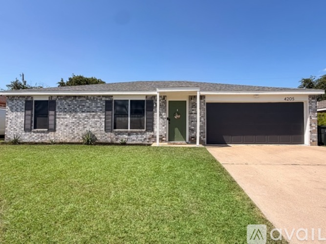 A house with a garage and a driveway in front.