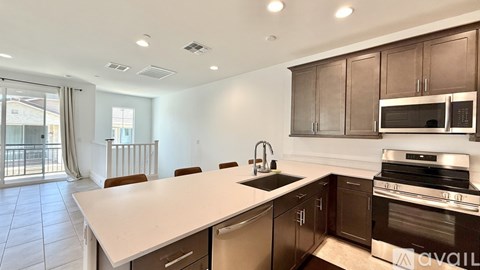 A kitchen with brown cabinets and a white countertop.