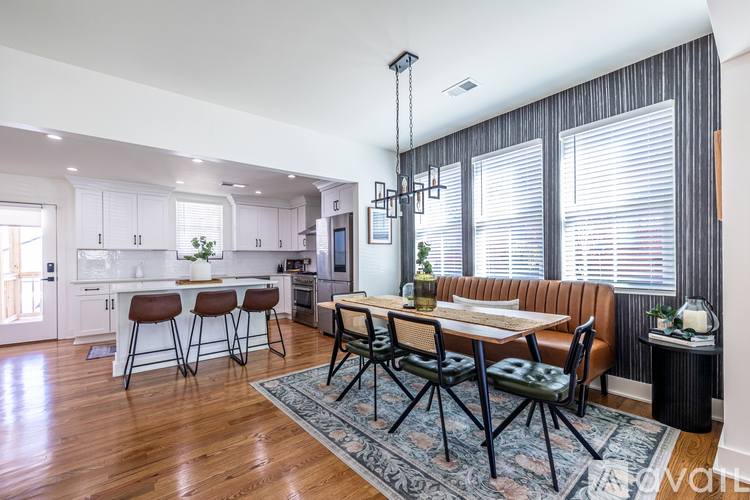 A modern kitchen with a dining table and chairs.