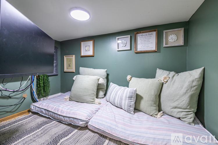 A bedroom with a bed and a green wall.