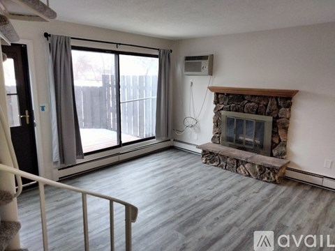 A living room with a fireplace and sliding glass doors.
