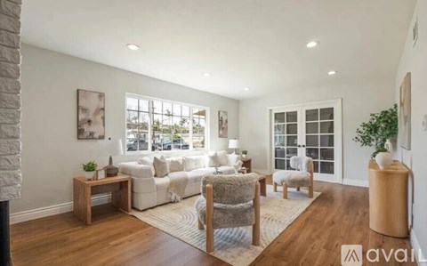 A living room with a white couch and a wooden coffee table.