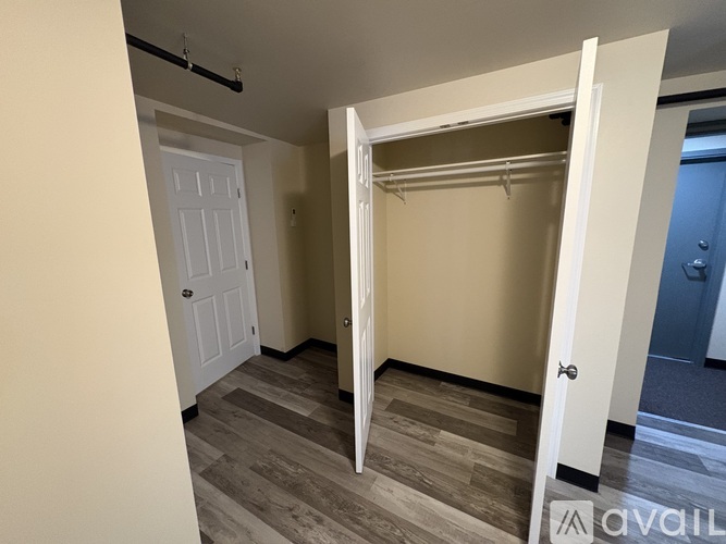 A room with a white door and a closet with a white door.