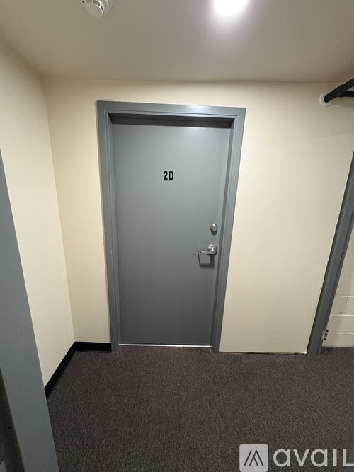 A grey door with the number 2D on it.