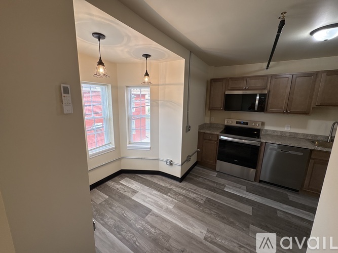 A kitchen with a microwave, oven, and dishwasher.