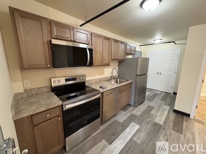 A kitchen with a stove top oven and microwave.