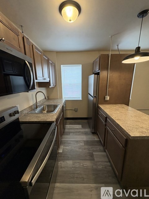 A kitchen with a black oven and a sink.