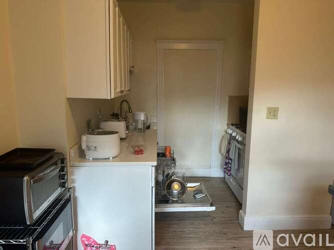 A kitchen with a white fridge and a black oven.