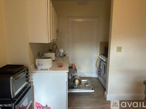 A kitchen with a white fridge and a black oven.