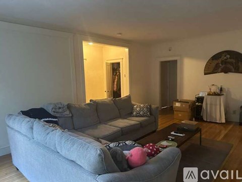 A living room with a grey sofa and a coffee table.