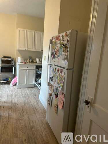 A kitchen with a fridge covered in magnets.