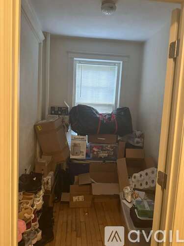A room with boxes and items scattered about.