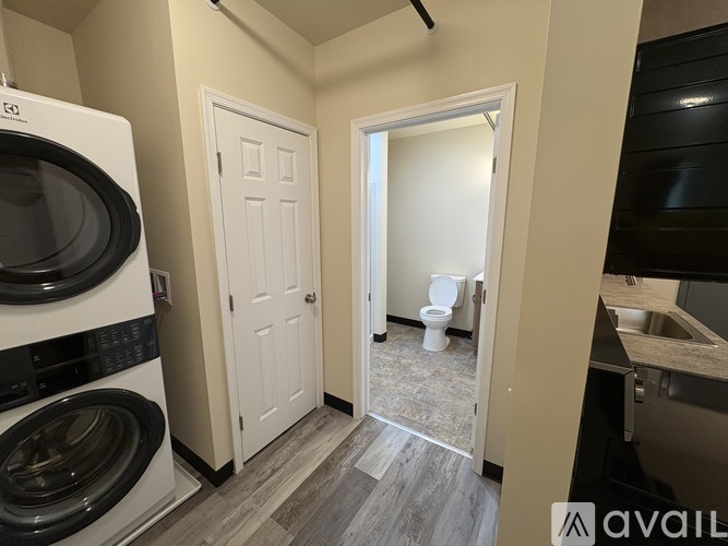 A small laundry room with a washer and dryer.