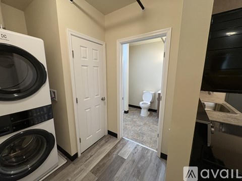 A small laundry room with a washer and dryer.