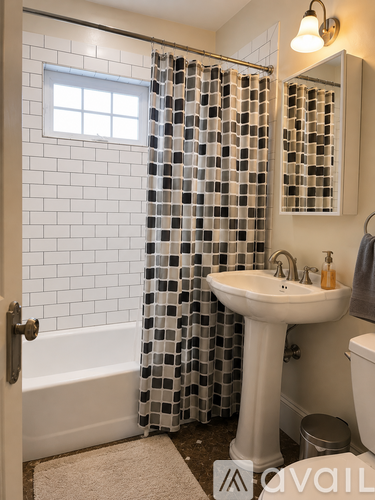 A bathroom with a white sink and a shower curtain.