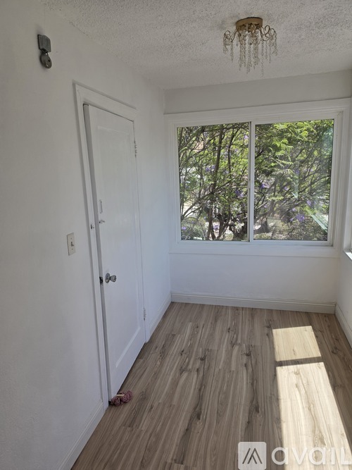 A room with a ceiling fan and a window.