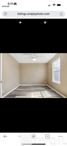 A room with a wooden floor and a window.