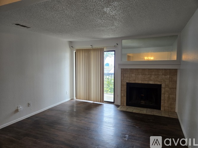 A living room with a fireplace and sliding glass doors.