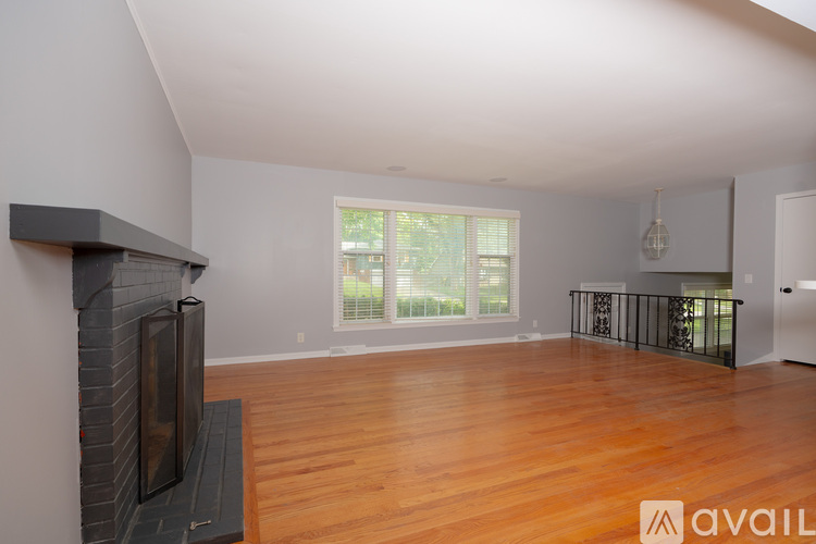 A living room with a fireplace and a television.