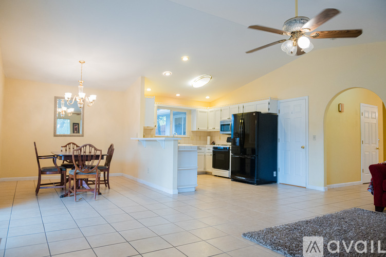 A kitchen with a dining table and chairs in the middle of the room.