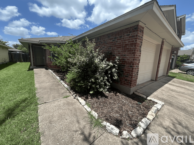 A house with a white garage door and a brick exterior.