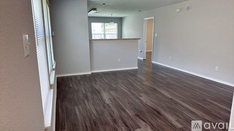 A kitchen with wooden cabinets and a countertop is available for rent.