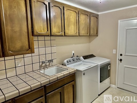 A kitchen with a white oven and a white door.