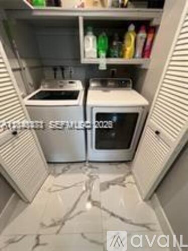 A kitchen with a stove and microwave built into the cabinetry.