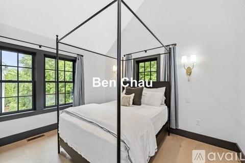 A bedroom with a four poster bed and a window.