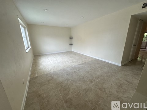 A room with beige walls and a tiled floor.