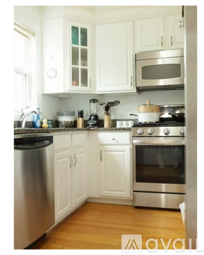 A kitchen with white cabinets and stainless steel appliances.