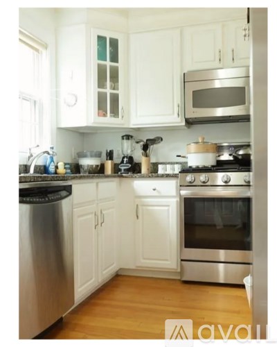 A kitchen with white cabinets and stainless steel appliances.