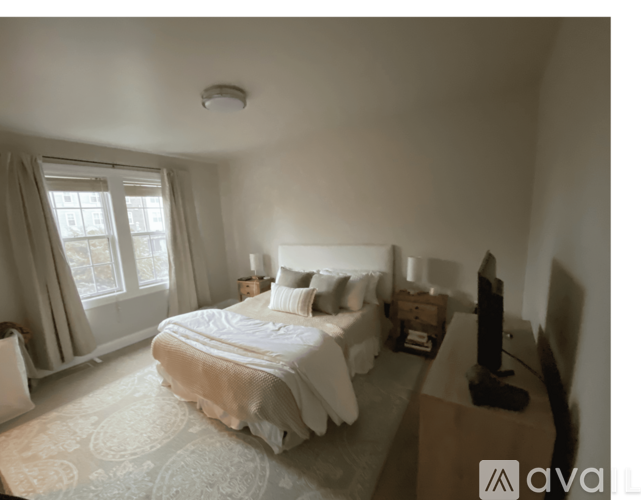 A bedroom with a large bed and a flat screen TV.