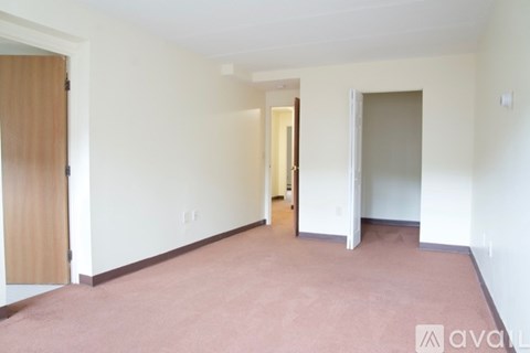 A room with a carpeted floor and white walls.