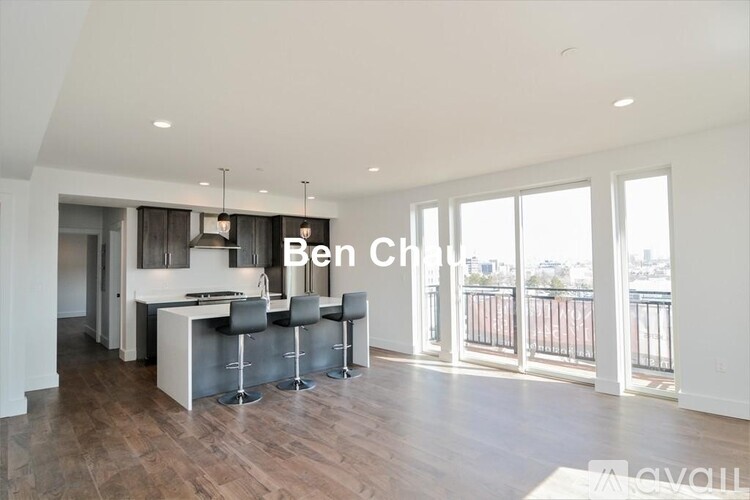 A modern kitchen with a bar area and a view of the city.