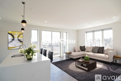 A modern living room with a white sofa and a coffee table.
