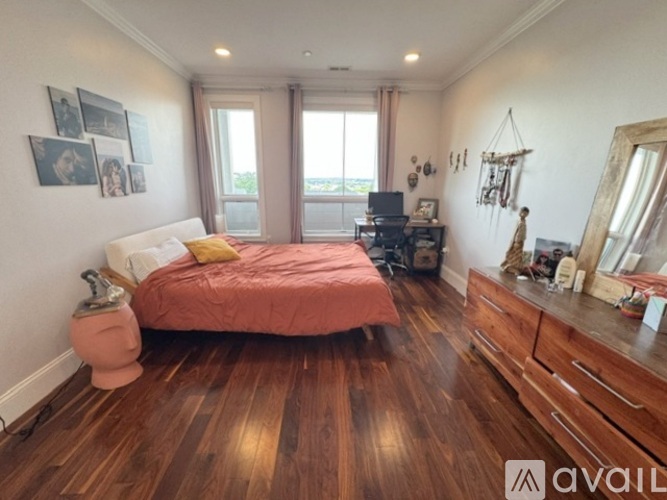 A bedroom with a bed, dresser, and mirror.