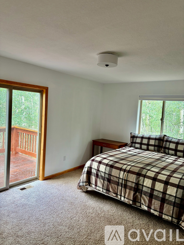 A bedroom with a bed and a window.