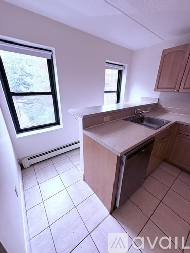 A kitchen with a sink and a window.