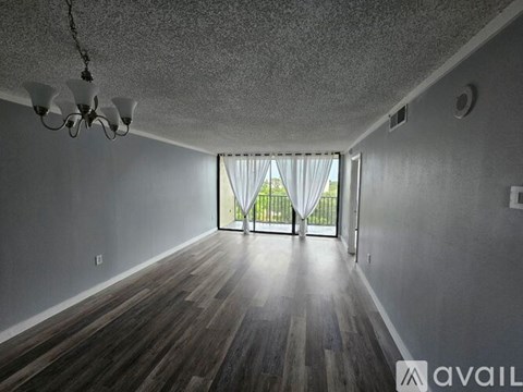 A room with wooden floors and a chandelier.