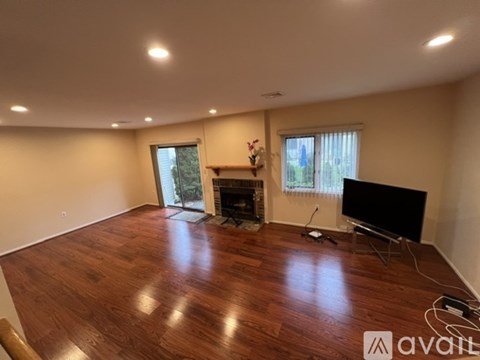 A living room with a fireplace and a television.