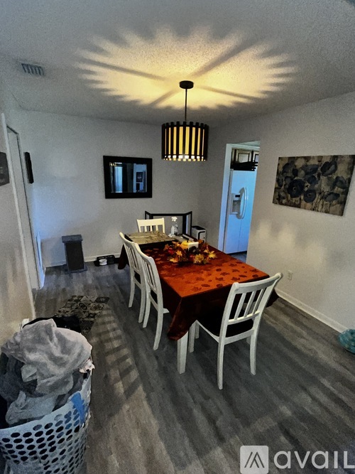 A dining room with a table set for four.