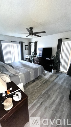 A bedroom with two beds and a dresser with a mirror.