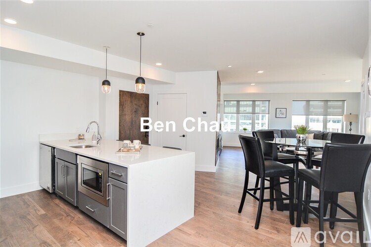 A modern kitchen with a dining table set for four.