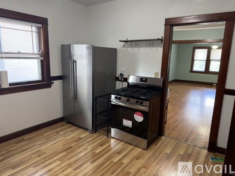 A kitchen with a stainless steel refrigerator and a black stove top oven.