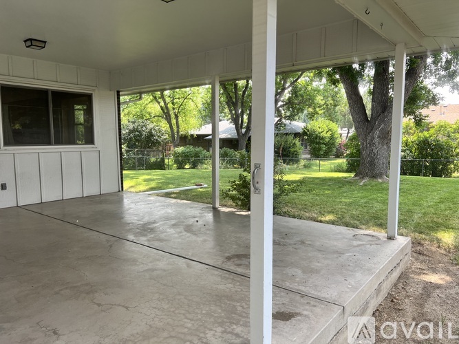 A patio with a white roof and concrete floor.